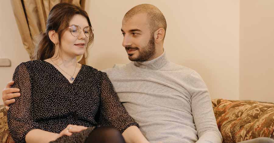 Man and woman sitting on a couch