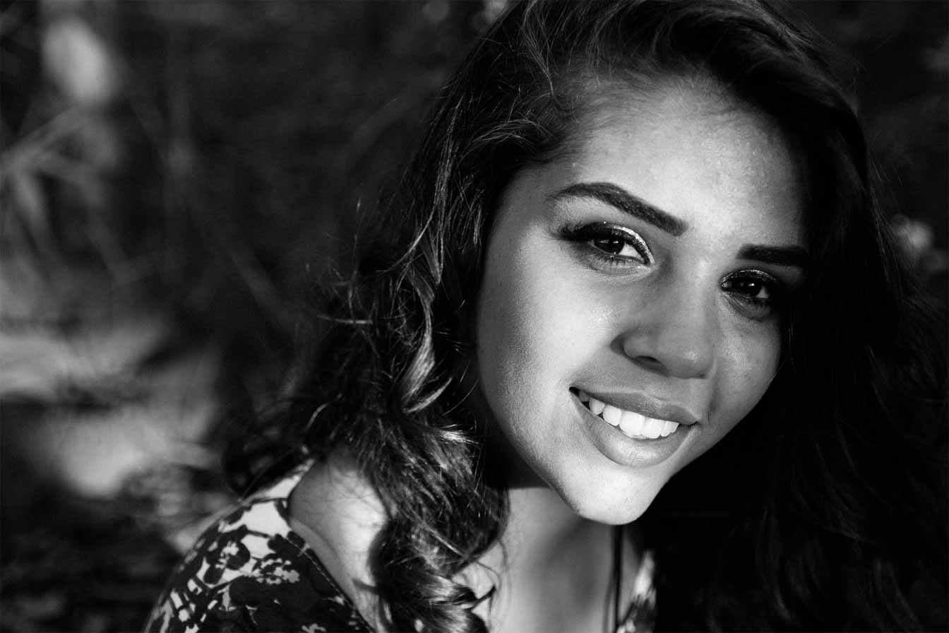  A black and white photo of a smiling Colombian woman